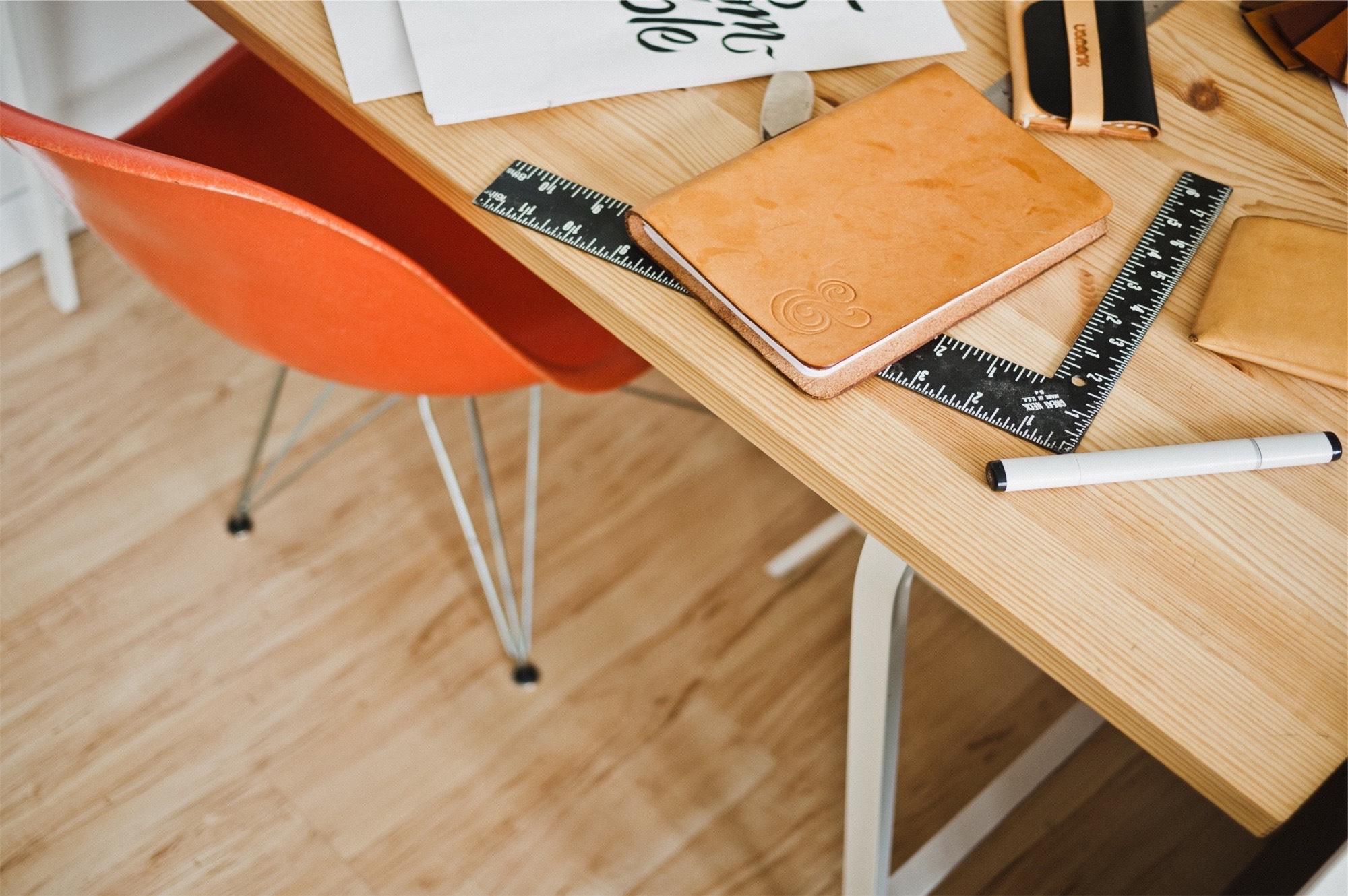 a chair sitting in front of a wooden table